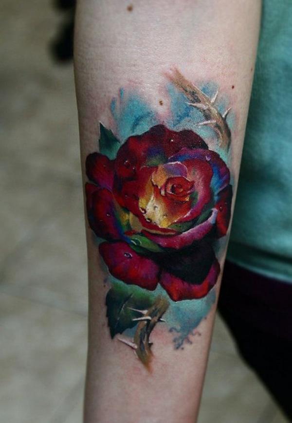 Painted red rose tattoo with water droplets