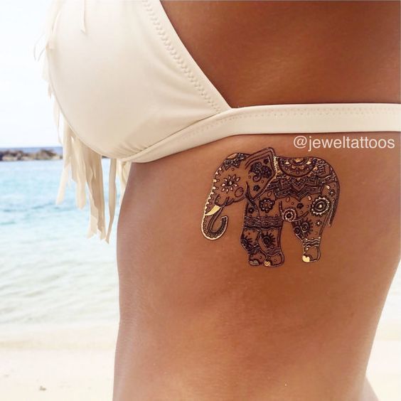 A beautifully decorated mandala elephant tattoo on the lady’s chest