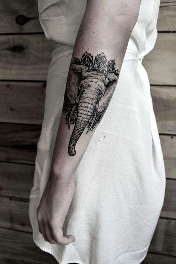 A large realistic elephant tattoo on the wrist