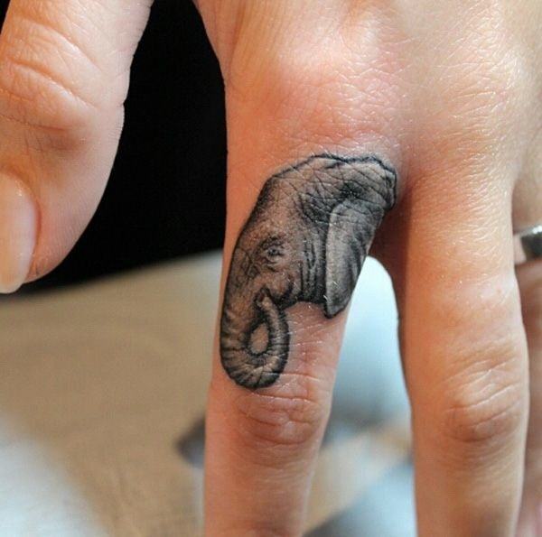 A baby elephant tattoo on the finger