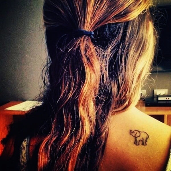 A baby elephant tattoo design on a ladies back