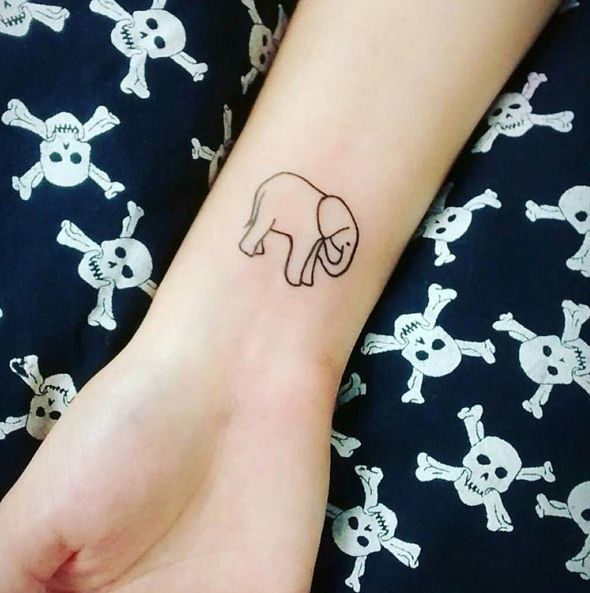 Simple clean elephant outline tattoo on the wrist