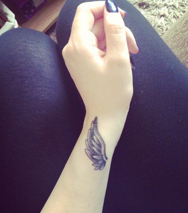 Angel wing tattoo on wrist
