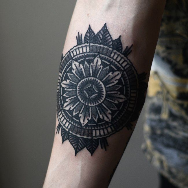 Concentric Circles and Leaves Arm Tattoos