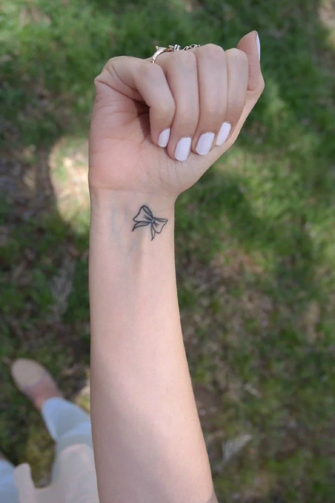 Cute Tiny Bow Tattoo On Finger