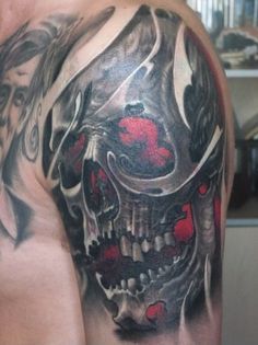 Awesome human skull tattoos on a man’s upper arm
