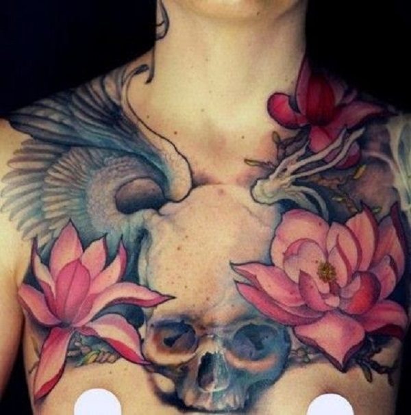Japanese inspired skull chest tattoo with lotus flowers