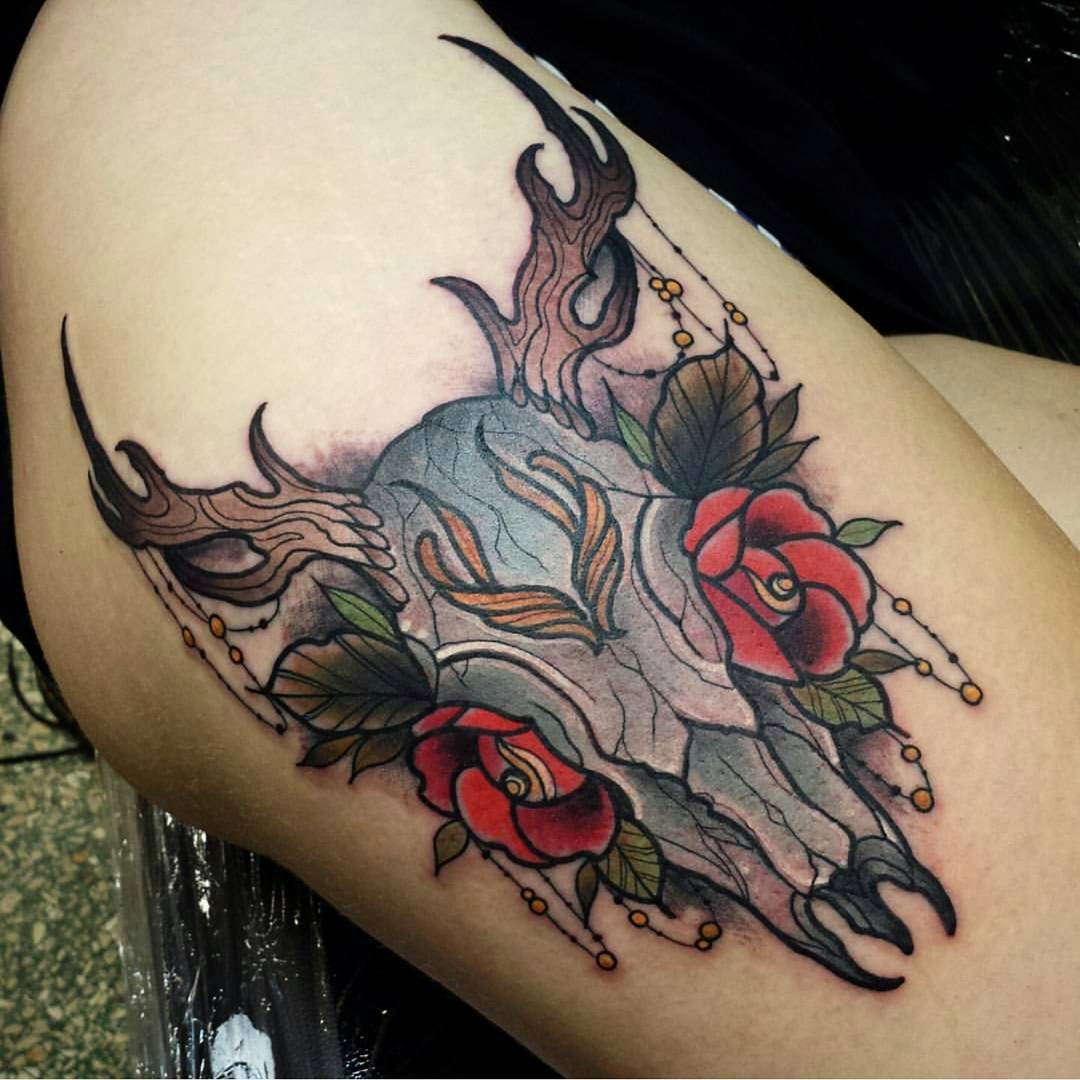 Colorful skull and rose tattoo