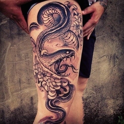 Snake and sword tattoo on the thigh