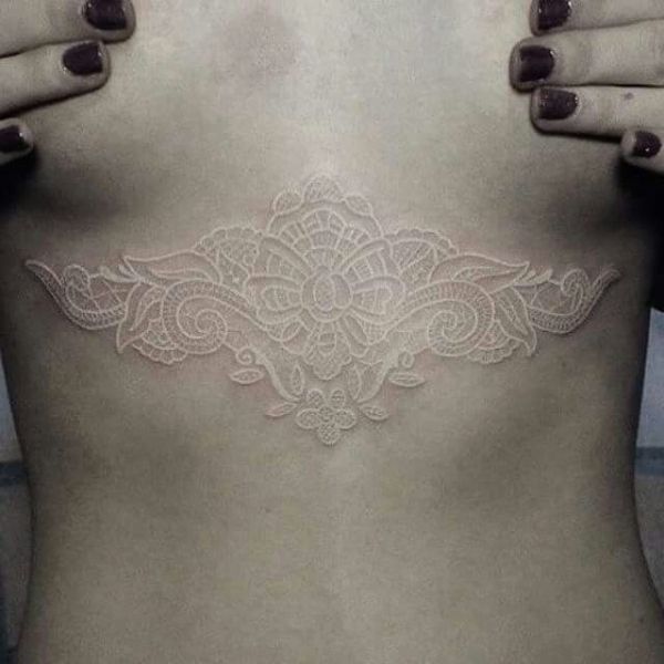 Lace Embellishments on the Chest White Ink Tattoos