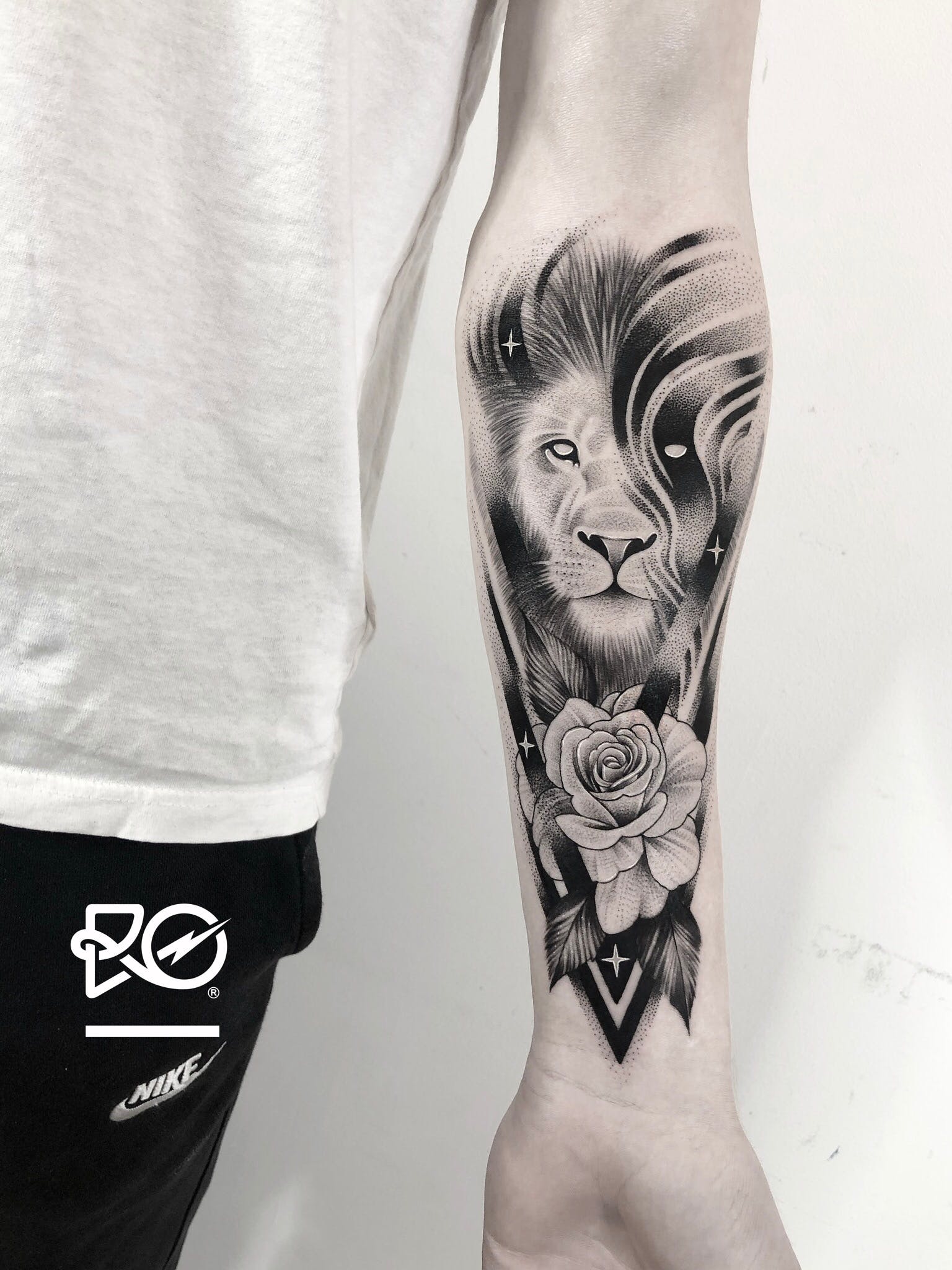 Lion Tattoo Ideas: Mystical Lion and Rose Tattoo on Forearm