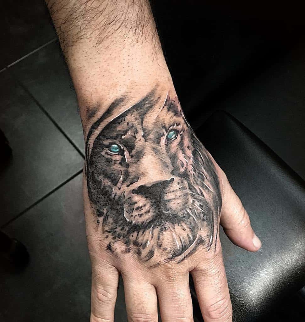 Lion Tattoo Ideas: Blue Eyed Lion Head Tattoo on Hand