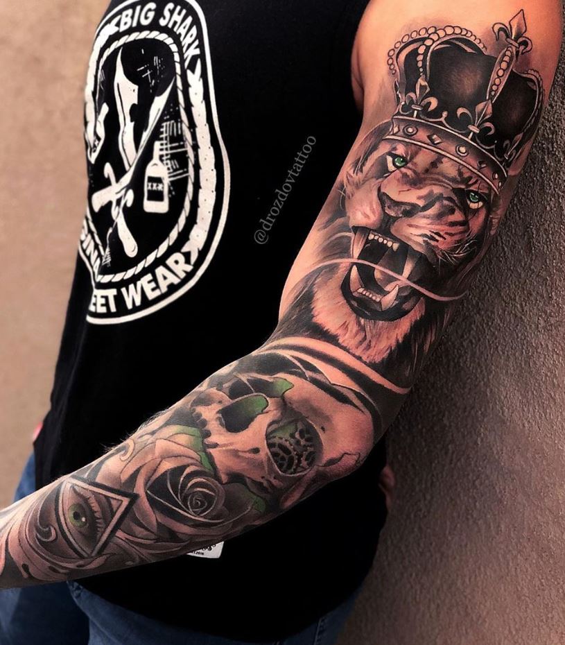 Lion Tattoo Ideas: Roaring Lion with Crown Arm Tattoo
