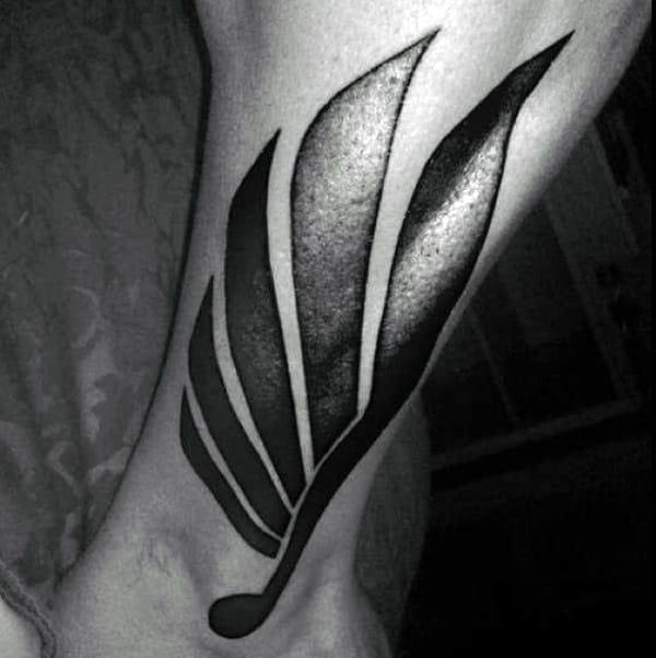 Stylized Wing In Deep Blacks ankle tattoos for Various Skin Tones