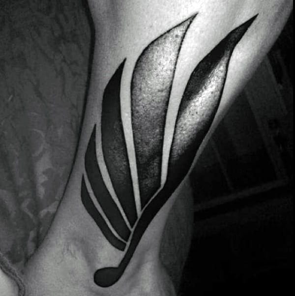 Stylized Wing In Deep Blacks ankle tattoos for Various Skin Tones