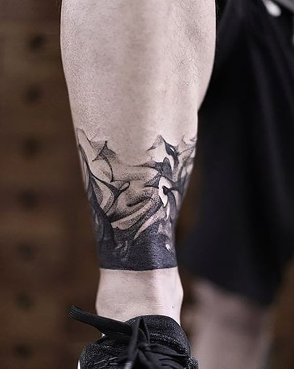 Delicate Swirls of Black Rising Leg ankle tattoos for Various Skin Tones