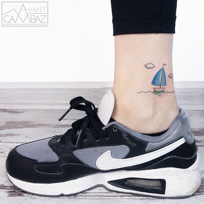 Tiny Sailboat on the Sea Ankle Tattoo Design
