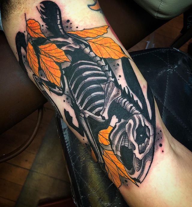 Rabbit Skeleton with Orange Leaves Inner Bicep Tattoo Ideas for Upper Arm