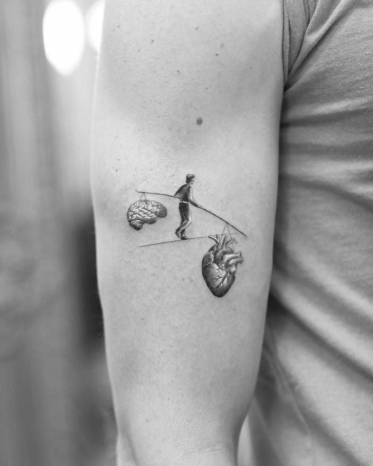 Man Balancing Heart and Mind Bicep Tattoo Ideas