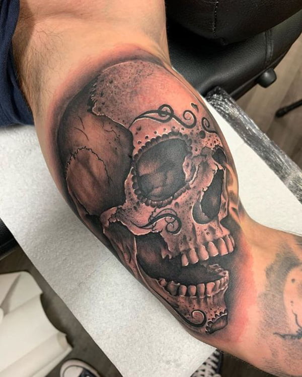 Human Skull Bicep Tattoos with Decorations Over It