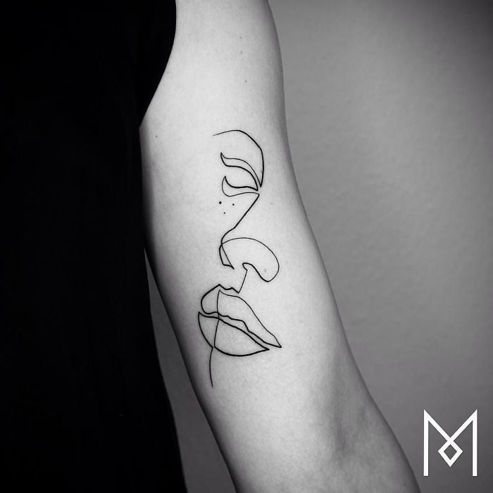 Single Line Creates Half a Face Inner Bicep Tattoos for Men