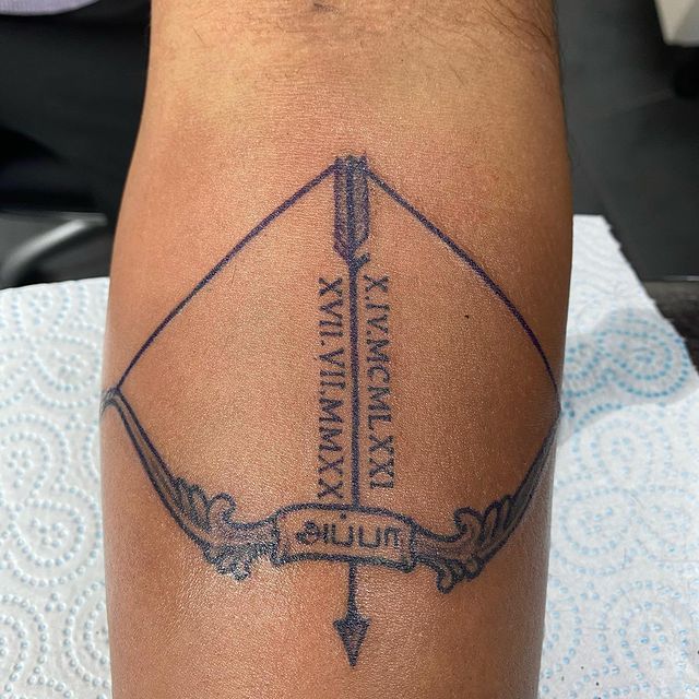 Bow with Roman Numeral Date Dedication Arrow Tattoo