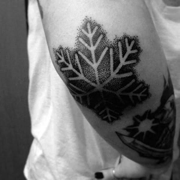 Negative Space Snowflake Tattoo on Elbow Tip Elbow Tattoos