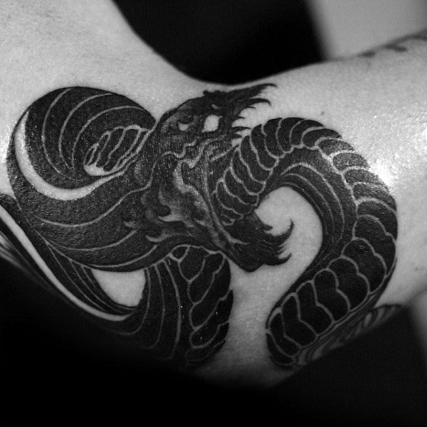 Dramatic Black Ouroboros in Unique Style Elbow Tattoos