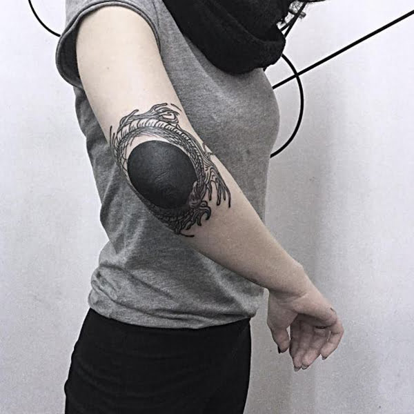 Ouroboros Surrounding a Pit of Black Elbow Tattoos