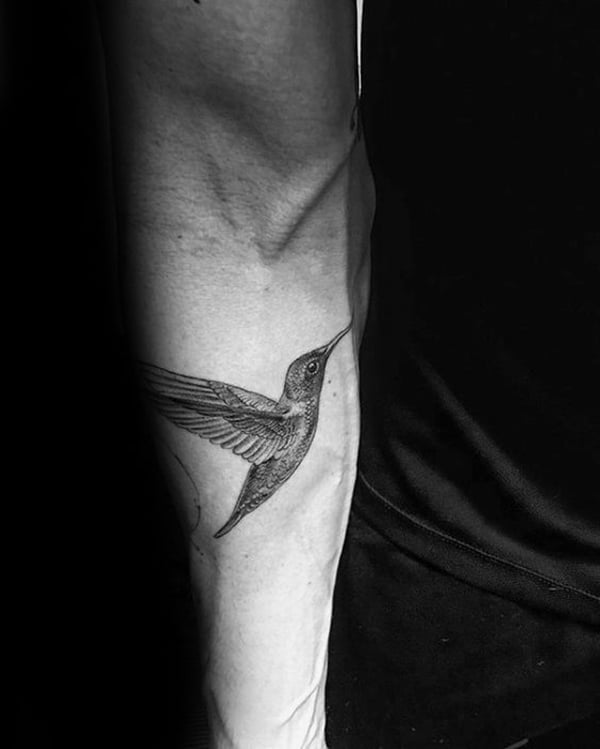 Intricately Detailed Fluttering Hummingbird Arm Tattoo