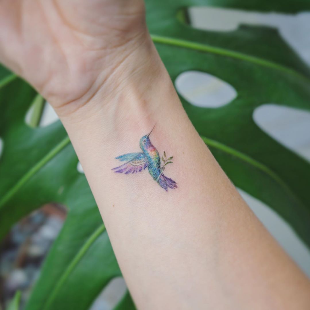 Pastel Hummingbird Tattoos Holding an Olive Branch for Tattoo Enthusiast