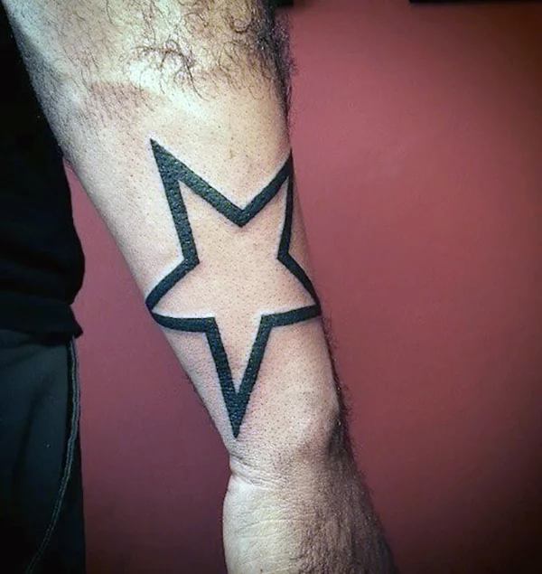 Galactic star tattoo on the right forearm